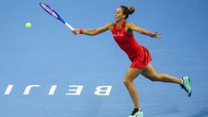 epa13294220 Zheng Qinwen of China in action against Elise Mertens of Belgium during their Women’s Singles semifinals match at the China Open tennis tournament in Beijing, China, 10 October 2026. China Open runs from 28 September through 11 October.  EPA/WU HAO
