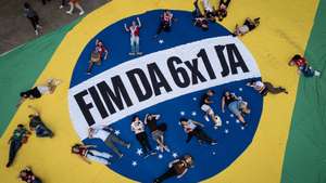 epa12927012 Aerial photograph showing people posing on a Brazilian flag during a demonstration in the commemoration of International Workers' Day in Sao Paulo, Brazil 01 May 2026.  EPA/Isaac Fontana