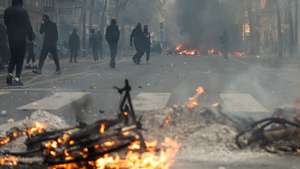 epa13312280 Flames and smoke rise during a demonstration against rising living costs and cuts to public services in Paris, France, 17 October 2026. The nationwide mobilization brought together Yellow Vest (Gilets Jaunes) activists, high school and university students, trade unions and other groups protesting rising living costs, fuel prices and deteriorating public services, while demanding improvements in education and school conditions.  EPA/MOHAMMED BADRA