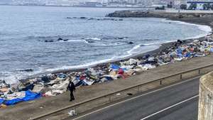 epa13282677 A person walks past the remains of a makeshift migrant encampment following a police operation to dismantle the camp on Trampolin beach in Ceuta, Spain, 05 October 2026. Trampolin Beach became the main informal settlement for migrants crossing into the enclave from Morocco since July 2026, sparking local tension and public safety concerns.  EPA/RAFAEL PENA