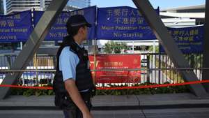 epa13274334 A Hong Kong police officer walks along a bridge in Hong Kong, China, 01 October, 2026. The city celebrates China's National Day on 01 October 2026, marking the 77th founding anniversary of the People's Republic of China.  EPA/MAY JAMES