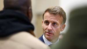 epa13325875 French President Emmanuel Macron (R) meets community members at the town hall in Trappes, near Paris, France, 23 October 2026. The visit follows a drive-by shooting that killed one person and wounded at least four others, including a 12-year-old girl.  EPA/HANNAH MCKAY / POOL MAXPPP OUT