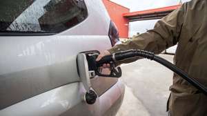 epa09863195 A man fills up his at a gas station in the town of Sant Luis, Menorca island, eastern Spain, 01 April 2022. The Spanish Government began on 01 April to subsidize the fuel price with a minimum reduction of 20 euro cents per liter of fuel to try to deal with the hike of prices amid the Russian invasion of Ukraine and after a strike called by hauliers. The measure will be in effect until next 30 June.  EPA/David Arquimbau Sintes