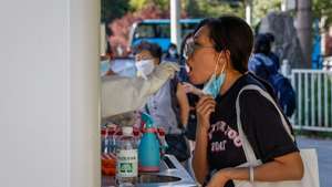 epa10054625 A woman undergoes a COVID-19 test in Beijing, China, 06 July 2022. China is fighting COVID-19 outbreaks across the country as the government has eased restrictions. Shanghai has recorded cases linked to an illegally operating karaoke lounge, while more than one million people are under lockdown in Anhui province. In Xian, Shaanxi province, a seven-day closure of entertainment venues and suspension of dine-in services has been enforced after detecting eleven cases on 05 July.  EPA/MARK R. CRISTINO