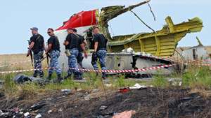 epa08255990  (FILE) - Armed rebel soldiers pass in front of a big piece of debris at the main crash site of the Boeing 777 Malaysia Airlines flight MH17, which crashed while flying over the eastern Ukraine region, near Grabovo, some 100 kilometers east from Donetsk, Ukraine, 19 July 2014. 
The District Court in The Hague on 09 March 2020 is due to start a trial against four people believed of being involved in the shooting down of a civil Boeing 777 plane over Ukraine on 17 July 2014. Dutch prosecutors charge three people with Russian citizenship and a Ukrainian national over the downing of Malaysia Airlines Flight MH17 from Amsterdam to Kuala Lumpur in which 283 passengers and 15 crew members on board were killed. Most of the victims were Dutch, Malaysian and Australian nationals. A Joint Investigation Team (JIT) from Belgium, Ukraine, Australia and Malaysia in their report came to the conclusion that a Russian-made BUK missile that hit the plane was fired from territory controlled by pro-Russian rebels. Russia has denied any responsibility for the downing and blamed Ukraine for the tragedy. It is not expected that the four accused will attend the trial as Russian law would prohibit their extradition.  EPA/ROBERT GHEMENT *** Local Caption *** 51488376