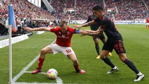 epa10586017 Mainz’s Silvan Widmer (L) in action against Munich&#039;s Joao Cancelo (R) during the German Bundesliga soccer match between 1. FSV Mainz 05 and FC Bayern Munich in Mainz, Germany, 22 April 2023.  EPA/RONALD WITTEK ATTENTION: The DFL regulations prohibit any use of photographs as image sequences and/or quasi-video.