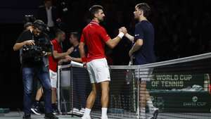 epa10991657 Novak Djokovic (L) of Serbia celebrates his victory over Cameron Norrie (R) of Great Britain in their singles match of the Davis Cup quarter final tie between Serbia and Great Britain in Malaga, Spain, 23 November 2023.  EPA/Jorge Zapata