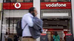 epa10631380 People walk past a Vodafone shop on Oxford Street in London, Britain, 16 May 2023. Vodafone has announced it will cut 11,000 jobs over the next three years from its global workforce. The UK telecoms company aims to simplify its organisation with the planned job cuts that amount to more than a tenth of the 104,000 staff worldwide.  EPA/TOLGA AKMEN