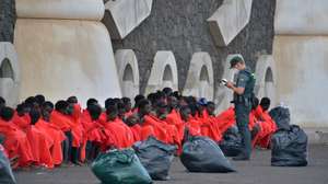 epa10928742 An officer checks 148 sub-Saharan immigrants that include 20 minors and eight women, after arriving at the port of La Restinga, El Hierro, Canary Island, Spain, 20 October 2023.  EPA/Gelmert Finol