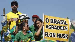 epa11292745 A protester holds a banner that reads 'Brazil Thanks Elon Musk' as supporters of former Brazilian president Jair Bolsonaro attend a march in Rio de Janeiro, Brazil, on 21 April 2024. Former Brazilian president Bolsonaro (2019-2022) called for a march to 'defend democracy and freedom of speech.'  EPA/Antonio Lacerda