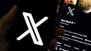 epa10772438 An illustration pictures shows a user holding a mobile phone displaying the 'X' logo in front of Elon Musk's page in Los Angeles, California, USA, 27 July 2023. Twitter announced on 23 July that it will rebrand to X.  EPA/ETIENNE LAURENT