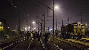 epa04979111 Migrants walk along the railway as they try to catch a train to reach England, in Calais, France, 15 October 2015. Dozens of minor breaches of security cordons are reported nightly, Eurotunnel has said. The company and French police tightened security in July and August after the number of refugees trying to force their way towards the tunnel had risen to some 2,000 nightly in June. Eurotunnel said it had intercepted 37,000 refugees this year by the end of July, while more than a dozen people have died during recent attempts to find a way through the tunnel. Many refugees live for months in crude encampments around Calais as they await a chance to reach Britain.  EPA/YOAN VALAT