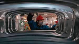 epa10974405 A person works in BYD electric cars factory in Changzhou, Jiangsu Province, China, 14 November 2023. According to published data, the output of BYD Changzhou base from January to July this year has exceeded 150,000 vehicles and the project has a planned annual production capacity of 400,000 vehicles.  EPA/ALEX PLAVEVSKI