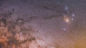 epa09987402 A rendered timelapse image shows red supergiant Antares next to Rho Ophiuchi nebula's three stars (R) and 'Rio Negro' dark star dust near of the Wilky Way and taken from La Lora wasteland in Cantabria, Spain, early 31 May 2022.  EPA/Pedro Puente Hoyos