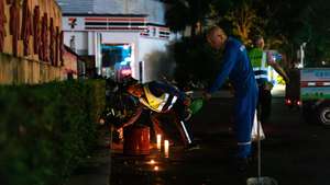 epa11716836 Workers remove flowers and candles left by mourners for the victims of a car ramming incident, at the entrance to the Zhuhai Sports Center in Zhuhai, China, 12 November 2024. According to state media, at least 35 people were killed and 43 others severely injured on the evening of 11 November after a car crashed into pedestrians in a sports center in Zhuhai, Guangdong Province. According to police, a 62-year-old suspect was being treated at a hospital after injuring himself.  EPA/ALEX PLAVEVSKI