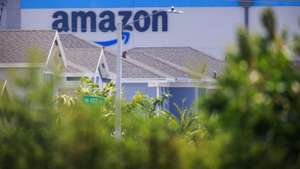 epa12060880 The Amazon logo is seen behind a neighborhood in Miami, Florida, USA, 28 April 2025. Amazon is scheduled to share its first-quarter 2025 results on 01 May 2025, according to the company.  EPA/CRISTOBAL HERRERA-ULASHKEVICH