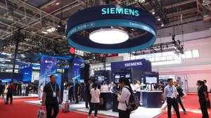 epa12242474 Visitors walk past the booth of German multinational technology conglomerate Siemens during the third China International Supply Chain Expo (CISCE) in Beijing, China, 17 July 2025. The 3rd CISCE exhibition runs from 16 to 20 July 2025 under the theme 'Connecting the World for a Shared Future'.  EPA/WU HAO