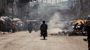 epa11957094 People use motorcycles on a street near the National Palace in Port-au-Prince, Haiti, 11 March 2025. One year after Ariel Henry announced his resignation as prime minister, Haiti is at a standstill.  EPA/Mentor David Lorens