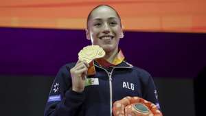 epa12478209 Gold medalist Kaylia Nemour of Algeria poses on the podium for the Uneven Bars Final of the Women's Artistic Gymnastics Apparatus Finals at the FIG Artistic Gymnastics World Championships 2025 in Jakarta, Indonesia, 24 October 2025.  EPA/MAST IRHAM