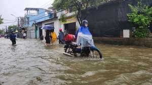 epa12178370 A handout photo made available by the Vietnam News Agency shows people walking through flood waters in Hue City, central Vietnam, 13 June 2025 (issued 16 June 2025). Six dead, and another remains missing in central Vietnam due to flooding triggered by Typhoon Wutip, according to the Vietnam Disaster and Dyke Management Authority.  EPA/VIETNAM NEWS AGENCY / HANDOUT VIETNAM OUTHANDOUT EDITORIAL USE ONLY/NO SALES