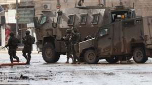 epa12614351 Israeli troops during a military operation in the Palestinian village of Qabatiya, near the West Bank city of Jenin, 27 December 2025. Israeli troops started a military operation after a  Palestinian from Qabatiya vilage killed two Israelis in a stabbing and car-ramming attack in northern Israel on December 26. Israeli forces have continued their operation against Qabatiya for the second consecutive day, imposing a tight siege accompanied by mass filed interrogations of dozens of residents, forced displacement, widespread home raids and searches, and massive destruction of infrastructure.  EPA/ALAA BADARNEH