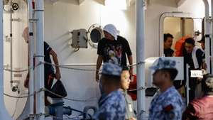 epa12681368 Filipino crew members of the cargo ship M/V Devon Bay disembark from a Philippine Coast Guard (PCG) vessel at the port of Manila, Philippines. 26 January 2026. The PCG on 25 January received custody of 15 ship crew who survived and the remains of two who died after Chinese Coast Guard units pulled the Filipinos from disputed waters of the South China Sea after the M/V Devon Bay reportedly capsized on 23 January.  EPA/ROLEX DELA PENA