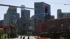 epa12901579 vPeople walk in Beijing's Central Business District (CBD) in Beijing, China, 20 April 2026. The People's Bank of China held the loan prime rates in April at 3 percent for one-year loans and 3.5 percent for five-year loans.  EPA/WU HAO