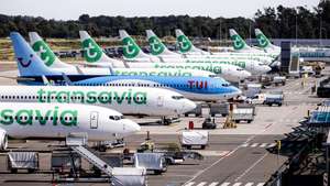 epa11568719 Dutch airline Transavia and German TUI's airplanes are parked on the tarmac of Eindhoven Airport, in Eindhoven, the Netherlands, 28 August 2024. Air traffic was put on hold on 28 August at Eindhoven Airport due to a malfunction, the airport said in a statement. The cause of the issue is currently being investigated.  EPA/ROB ENGELAAR