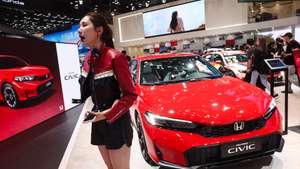 epa12911642 A visitor poses beside cars displayed at the Honda stand during the 2026 Beijing International Automotive Exhibition in Beijing, China, 24 April 2026. The biennial auto show runs from 24 April to 03 May 2026.  EPA/WU HAO