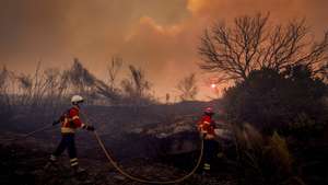 A firefighter fights the flames during a wildfire in Valpacos, Portugal, 30th July 2026. The fire, which broke out on Tuesday in the municipality of Valpaços and spread to those of Mirandela and Vinhais, has three active fronts this evening, and additional resources and personnel have been deployed, according to the Civil Protection Agency. PEDRO SARMENTO COSTA/LUSA