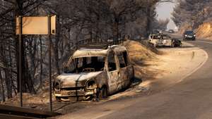 epa13168747 Burnt-out cars are seen on a road after a wildfire near the town of Omis, Croatia, 14 August 2026. Wildfires across the region have forced the evacuation of around 2,000 residents, with at least seven people being treated for life-threatening injuries.  EPA/STRINGER