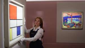 epa11366012 A worker poses with the work Composition C (No.III) with Red, Yellow and Blue” by Dutch artist Piet Mondrian at a preview of London: An Artistic Crossroads at Sotheby’s auction House in London, Britain, 24 May 2024. The exhibition is in partnership with 12 UK Museums and Art UK and runs from Opening 25 May to 5 July 2024  EPA/NEIL HALL