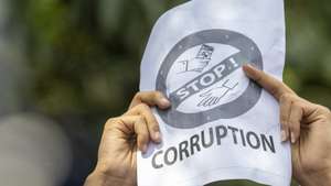 epa12362233 A protester holds a placard during clashes with police in front of the parliament building in Kathmandu, Nepal, 08 September 2025. Young demonstrators gathered in the capital to demand an end to corruption and the lifting of social media bans. The government shut down 26 platforms, including Facebook, YouTube, Instagram, and WhatsApp, after they refused to register in Nepal. At least six people were killed and dozens were injured during the protest.  EPA/NARENDRA SHRESTHA