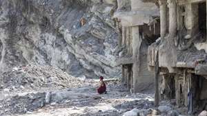 epaselect epa13218953 A Buddhist monk crouches in front of a house damaged by flash floods as he performs a 13th-day ritual in Dhunge, Nuwakot district, Nepal, 07 September 2026. Nepal is observing a national day of mourning on the 13th day following devastating flash floods. More than 1,200 people have been killed, and over 4,000 remain missing across northern Nepal after a glacial collapse and avalanche-triggered flash floods and mudslides along the Bhotekoshi and Trishuli river valleys near the Nepal-Tibet border, causing widespread destruction to settlements and infrastructure, according to the National Disaster Risk Reduction and Management Authority (NDRRMA).  EPA/NARENDRA SHRESTHA