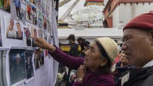 epa13242961 Family members look at photographs of people who lost their lives in flash floods that struck near the Nepal-Tibet border, during a condolence prayer meeting for those who died in the Bhotekoshi flash floods, at Boudhanath Stupa in Kathmandu, Nepal, 16 September 2026. Hundreds of Buddhist monks and family members of victims attended the three-day condolence prayer meeting, organized to pray for the souls of those who died in the disaster. More than 5,000 people remain missing and at least 1,300 people have been killed in floods triggered by a glacial collapse near the Nepal-Tibet border, according to the National Disaster Risk Reduction and Management Authority (NDRRMA).  EPA/NARENDRA SHRESTHA