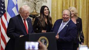 epa12852570 (L-R) US President Donald Trump, US Ambassador to Greece Kimberly Guilfoyle, Greek-American billionaire John Catsimatidis and his wife Margo Catsimatidis react during a Greek Independence Day celebration in the East Room of the White House in Washington, DC, USA, 26 March 2026. President Trump issued an official proclamation designating 25 March 2026, as 'Greek Independence Day: A National Day of Celebration of Greek and American Democracy'.  EPA/WILL OLIVER / POOL