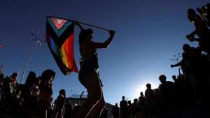 epa09309313 A participant waves a rainbow flag as people take part in the LGBT Pride Parade in Madrid, Spain, 28 June 2021. The Spanish association 'Madrid's Critical Pride' (Orgullo CrÃ­tico) organized the march under the slogan 'Neither Assigned Sex, Nor Proven Gender. Trans Fury Against All Authority' to call for equal rights and treatment around the world.  EPA/Rodrigo Jimenez