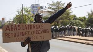 epa08953197 A man from Mali protests against France as security forces gather behind him in the capital Bamako, Mali 20 January 2021. Demonstrators were dispersed by police using tear gas as they tried to gather to protest against France's military role in Mali. Mali fell under French colonial rule in 1892 until independence in 1960. France intervened in the country in 2013 to help drive back advancing jihadist forces and now has approximately 5100 troops deployed across the Sahel.  EPA/HADAMA DIAKITE