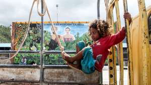 epaselect epa05726510 An East Timorese girl plays swing on a truck at Taibesi traditional market in Dili, East Timor, also known as Timor Leste, 18 January 2017.  EPA/ANTONIO DASIPARU