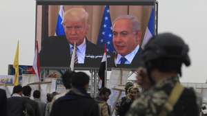 epa13117707 A digital billboard features (L-R) US President Donald Trump and Israeli Prime Minister Benjamin Netanyahu, as Houthi supporters stage a protest against Saudi Arabia, in Sana'a, Yemen, 17 July 2026. Thousands of Houthi supporters demonstrated in Sana'a against Saudi Arabia a day after Houthi leader Abdul-Malik al-Houthi threatened to target Saudi oil facilities if Riyadh escalated its military involvement in Yemen. Saudi Arabia has supported the Yemeni government militarily and politically since 2015, after Houthi forces seized much of northern Yemen.  EPA/YAHYA ARHAB