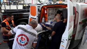 epa11590022 Palestinian healthcare workers load a stretcher with the body of a US citizen onto an ambulance outside Rafidia Hospital in the West Bank city of Nablus, 06 September 2024. According to the Palestinian news agency WAFA, a 26-year-old activist succumbed to her wounds after being shot in the head by Israeli forces during a protest against settlement expansion in Beita, near Nablus, on 06 September. Palestinian officials named the victim as US citizen and activist Esnor Ezki. She was taken to hospital, where she was pronounced dead, WAFA added.  EPA/STRINGER