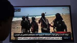 epa13294863 A person watches a television broadcast showing Saudi-backed Yemeni troops at a position on the Red Sea coast near the Bab al-Mandeb Strait in Sana'a, Yemen, 10 October 2026. The Saudi-led coalition supporting the Yemeni government announced that it had launched a large-scale military operation aimed at weakening the Houthis' ability to launch aerial attacks against Saudi territory and resist ground offensives by Yemeni government forces seeking to retake Houthi-controlled areas.  EPA/YAHYA ARHAB