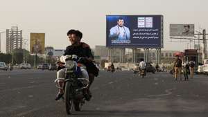 epaselect epa12958124 People ride a motorcycle past a digital billboard featuring Houthi leader Abdul-Malik al-Houthi in Sana'a, Yemen, 14 May 2026. Yemen's internationally recognized government and the Houthis have signed a UN-sponsored agreement to exchange more than 1,700 conflict-related detainees, marking the largest prisoner exchange since the outbreak of Yemen's war in 2014, according to a statement by the UN envoy to Yemen, Hans Grundberg.  EPA/YAHYA ARHAB