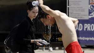 epa13075093 A man cools off with water at a public tap in downtown Zagreb, Croatia, 30 June 2026. Reports state that in recent days Croatia has recorded high temperatures exceeding 39 degrees Celsius. Europe is bracing for a heatwave, as forecasters predict temperatures are expected to climb above 40 degrees Celsius.  EPA/ANTONIO BAT
