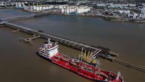 epa12889041 An image made with a drone shows the Maltese registered Flyoz chemical and oil oil tankers delivering to gas and fuel storage units at the Navigator Terminal in Grays, Britain, 14 April 2026. Oil prices have risen above 100 US dollars a barrel again as the US Navy begins a blockade of the Strait of Hormuz following the collapse of ceasefire negotiations between Iran and the United States. Meanwhile, leasing of electric vehicles has surged across Europe amid rising petrol prices linked to the Iran war.  EPA/NEIL HALL