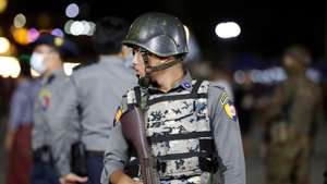 epa10232827 An armed police stands guard inside the people park during the fullmoon day of Thadinkyut festival (end of Buddhist lent) in Yangon, Myanmar, 09 October 2022. Thadinkyut festival, also called Lighting Festival, is held to mark the full moon day of the Burmese Lunar month of Thadingyut on 24 October, which is the end of Buddhist lent, and is the celebration to welcome the Buddha's descent from heaven.  EPA/NYEIN CHAN NAING
