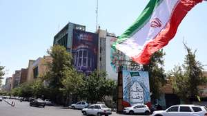 epa13114467 Iranians drive past an anti-US billboard featuring pictures of US President Donald Trump and his family on top of US flag-draped coffins, accompanied by a sentence in Persian that reads 'Blood for Blood,' that hangs at Palestine Square in Tehran, Iran, 16 July 2026. The US military has reinstated its naval blockade against Iranian ports and carried out strikes targeting Tehran's military capabilities, according to US Central Command (CENTCOM).  EPA/ABEDIN TAHERKENAREH 

RESTRICTIONS: NO Access Israel Media/Persian Language TV Stations Outside Iran/Strictly No Access BBC Persian/VOA Persian/Manoto TV/Iran International TV. (As mandated by Iran's Directorate General for Foreign Media)