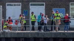 epa10105604 Migrants after disembarking a Border Force Volunteer rescue boat, which has escorted 90 migrants after they were picked up in the English Channel, Dover, Britain, 04 August 2022. A report from the United Nations High Commissioner for Refugees and the British Red Cross has found that critical gaps in the UK asylum system may result in people being at risk of potential exploitation when they arrive in the UK.  EPA/STUART BROCK