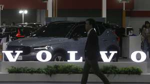 epa10727606 A visitor walks past the Volvo logo at the Fast Auto Show Thailand and EV Expo 2023 trade show at BITEC in Bangkok, Thailand, 05 July 2023. The event is held between 05 and 09 July and will include displaying EV innovations such as energy storage system by Nuovo Plus, PTT EV Charger electric charging station and a simulated EV Station Pluz charging station. According to the Federation of Thai Industries, more than 16,400 new EV cars were registered in the country in March 2023.  EPA/NARONG SANGNAK