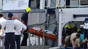 epa11447965 The body of a migrant is carried from the rescue vessel 'Humanity 1', operated by the German charity group SOS Humanity, in the port of Catania, Sicily Island, Italy, 30 June 2024. Humanity 1, carrying 186 migrants rescued off the coast of Lampedusa, entered the port of Catania, after being assigned by the Italian authorities.  EPA/ORIETTA SCARDINO